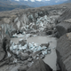 The ice-walled canyon at the terminus of the Kaskawulsh Glacier, with recently collapsed ice blocks. This canyon now carries almost all meltwater from the toe of the glacier down the Kaskawulsh Valley and toward the Gulf of Alaska. (Credit: Jim Best/University of Illinois)